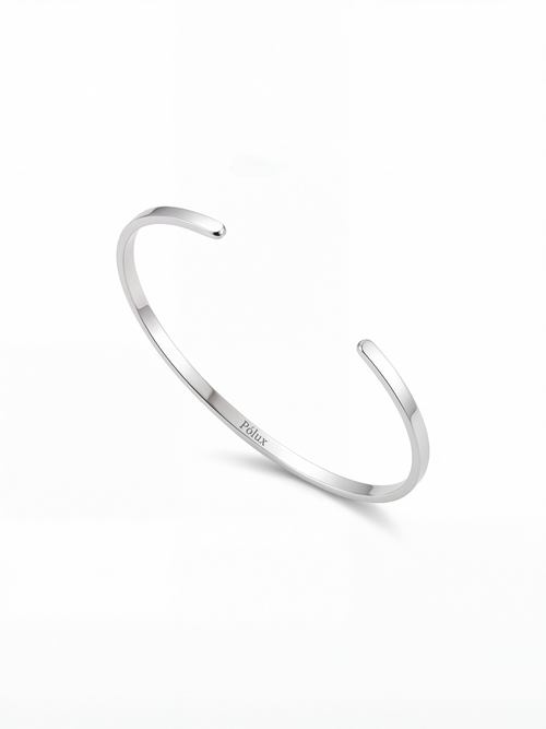 Brazalete plateado en acero quirúrgico con grabado Pólux, diseño minimalista unisex, acabado brillante.