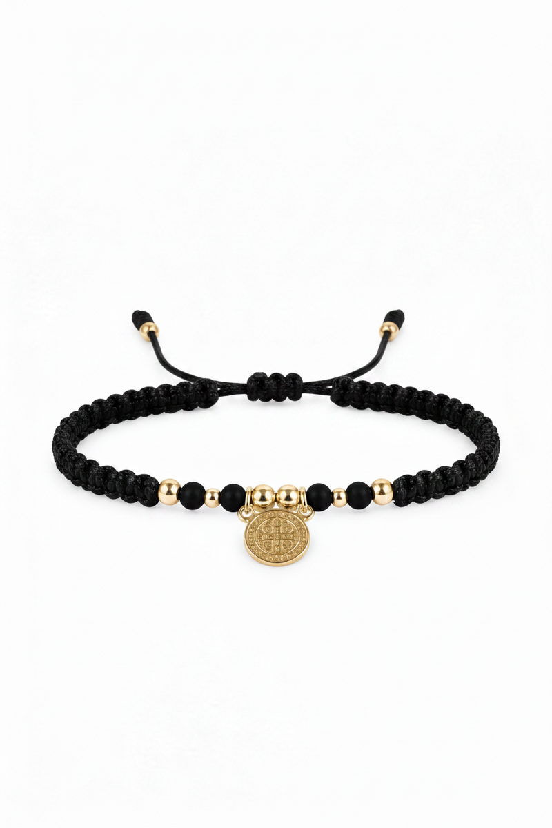 Pulsera San Benito tejida en macramé negro con oro laminado 18K sobre fondo blanco
