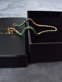 Pulsera tennis oro rosa circones verdes esmeralda acero quirúrgico