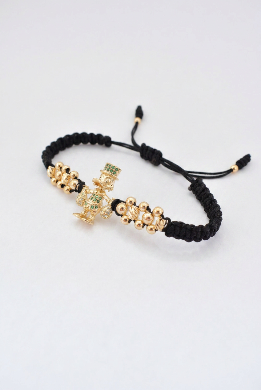 Pulsera Tío Rico en oro laminado 18K presentada dentro de la caja de regalo Pólux