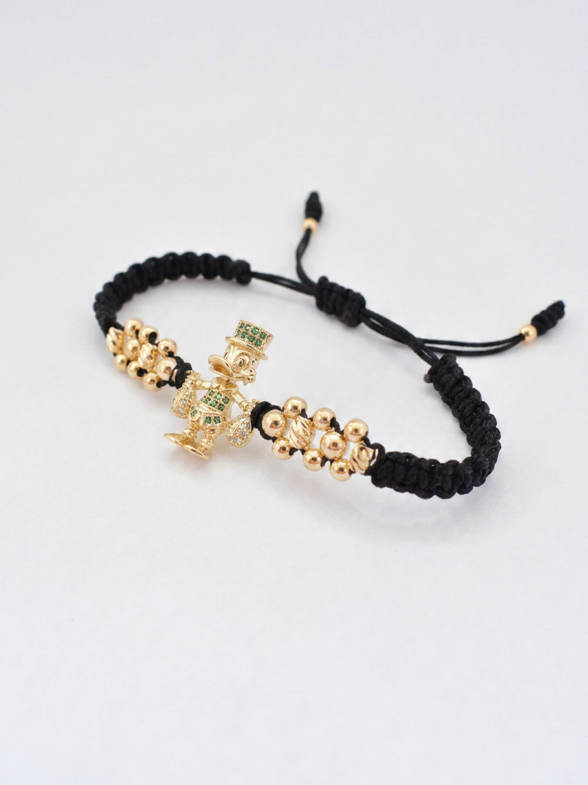 Pulsera Tío Rico en oro laminado 18K presentada dentro de la caja de regalo Pólux