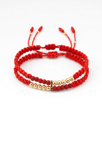 Set de pulseras Afrodita rojas en oro laminado 18K, vista frontal fondo blanco